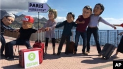Oxfam activists wearing masks of the leaders of the G-7 summit (from left) Italian Premier Paolo Gentiloni, US President Donald Trump, German Chancellor Angela Merkel, Japanese Prime Minister Shinzo Abe, French President Emmanuel Macron and Canadian Prime Minister Justin Trudeau, stage a demonstration in Giardini Naxos, near the venue of the G-7 summit in the Sicilian town of Taormina, May 26, 2017. 