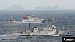 An aerial photo shows Chinese marine surveillance ships Haijian No. 49 (front) and Haijian No.50 cruising in the East China Sea, as the islands known as Senkaku isles in Japan and Diaoyu islands, April 23, 2013.