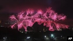 FILE - Fireworks explode behind Sydney's Opera House during New Year's celebrations, Australia, Dec. 31, 2013.