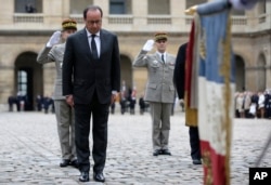 French President Francois Hollande attends a military ceremony in the courtyard of the Hotel National des Invalides, in Paris, Nov. 19, 2015.