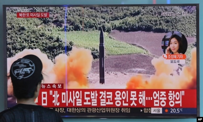 A woman watches a TV screen showing a file footage of North Korea's missile launch, at the Seoul Railway Station in Seoul, South Korea, Sept. 15, 2017.