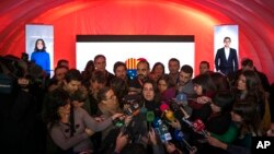 Ines Arrimadas, center, leader of the Citizens Party and candidate for the upcoming Catalan regional election, speaks with journalists during a campaigning event in Barcelona, Dec. 19, 2017.