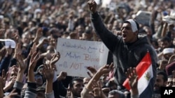 Anti-government protesters react in Tahrir Square, Cairo, Egypt, Friday, Feb. 4, 2011
