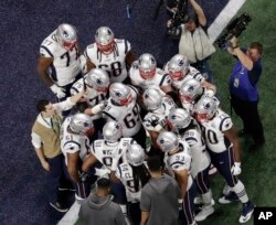 The New England Patriots huddle before the NFL Super Bowl football game between the Los Angeles Rams and the New England Patriots, Feb. 3, 2019, in Atlanta.