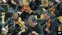 South Korean maestro Chung Myung-whun, director of the Radio France Philharmonic Orchestra, conducts the last rehearsal with North Korea's Unhasu Orchestra and Radio France Orchestra in Paris, March 14, 2012.
