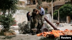 FILE - Members of the Islamist rebel group al-Nusra Front prepare a homemade mortar in the Bustan al-Qasr neighborhood of Aleppo, Syria, June 5, 2014. 