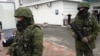 Unidentified gunmen on patrol at Simferopol Airport in Ukraine's Crimea peninsula, Feb. 28, 2014 (Elizabeth Arrott/VOA) 