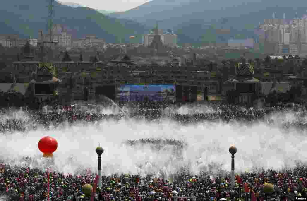 Para pengunjung berpartisipasi dalam festival air tahunan di Xishuangbanna, provinsi Yunnan, China, untuk merayakan Tahun Baru etnik minoritas Dai ke-1.377.