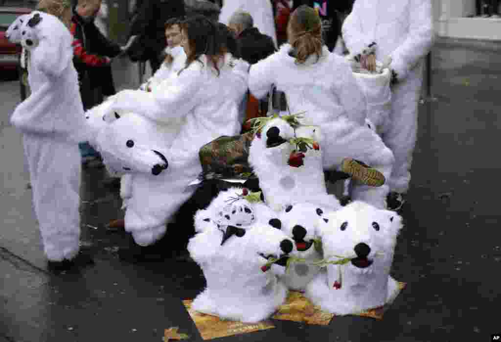 Activists wait with their bear costume before a demonstration near the Eiffel Tower.