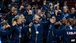 Tim bola voli putri AS merayakan kemenangan dalam Kejuaraan Dunia Bola Voli atas China di Milan, Italia (12/10). (AP/Emilio Andreoli)