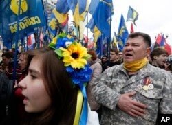 Members of nationalist groups take part in a rally to mark the third anniversary of the Maidan protests outside the Ukrainian Parliament in Kyiv, Ukraine, Feb. 22, 2017.