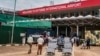 FILE - Passengers arriving on international flights leave the international arrivals lobby at Entebbe Airport in Uganda, March 3, 2020. 