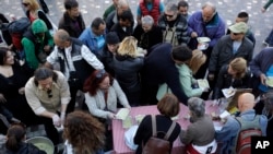 Soup kitchen volunteers hand out food in central Athens, which has seen high unemployment and a steady decline in living standards for most Greeks, April 25, 2017.
