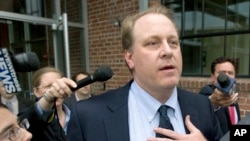  In this Wednesday, May 16, 2012, file photo, former Boston Red Sox pitcher Curt Schilling, center, is followed by members of the media as he departs the Rhode Island Economic Development Corporation headquarters, in Providence, R.I. 