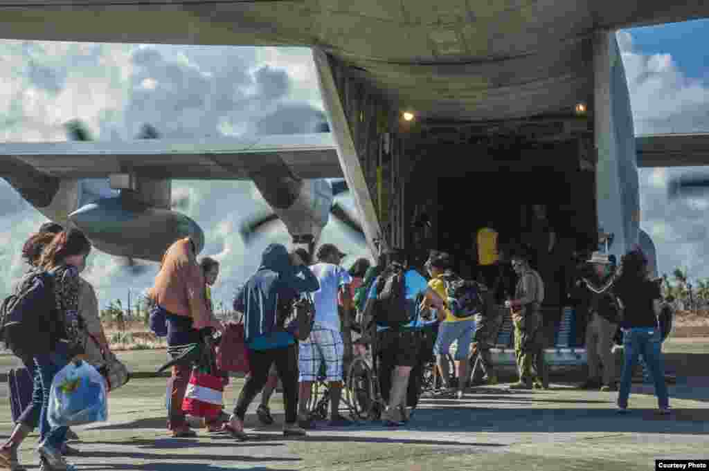 Philippine citizens board an HC-130 Hercules to be airlifted to safety. (U.S. Navy)