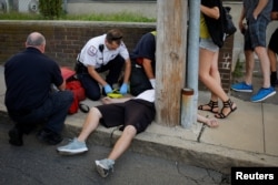 Cataldo Ambulance medics and other first responders revive a 32-year-old man who was found unresponsive and not breathing after an opioid overdose on a sidewalk in the Boston suburb of Everett, Massachusetts, Aug. 23, 2017.