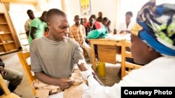 A Rwandan youth is tested for the AIDS virus before he receives a free male circumcision at the Shingiro Health Center in Musanze. (Courtesy the Global Fund) 