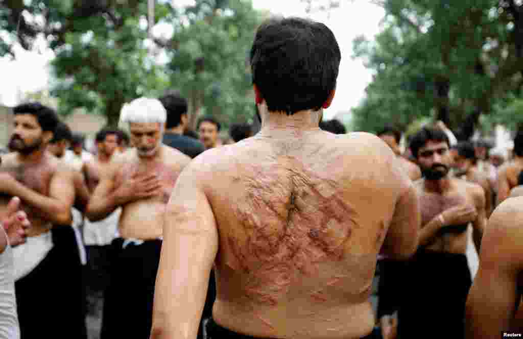 Men flagellate during the Shi&#39;ite Youm Ali procession in Islamabad, Pakistan.