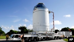 FILE - NASA's Orion spacecraft is moved toward the Payload Hazardous Servicing Facility at the Kennedy Space Center in Cape Canaveral, Florida. 