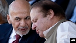 FILE - Afghan President Ashraf Ghani (left) talks with Pakistani Prime Minister Nawaz Sharif in Islamabad, Pakistan. 