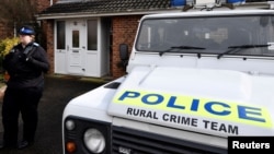 FILE - A police officer stands guard outside of the home of former Russian military intelligence officer Sergei Skripal, in Salisbury, Britain, March 6, 2018. 