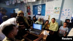 Rohingya refugees are registered by Bangladeshi army personnel at a registration center in Kutupalong refugees camp in Cox's Bazar, Bangladesh, October 20, 2017. REUTERS/ Zohra Bensemra - RC12DFD98A50