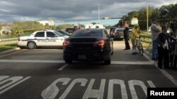 Police patrol the area outside Marjory Stoneman Douglas High School following a school shooting incident in Parkland, Florida, Feb. 15, 2018. 