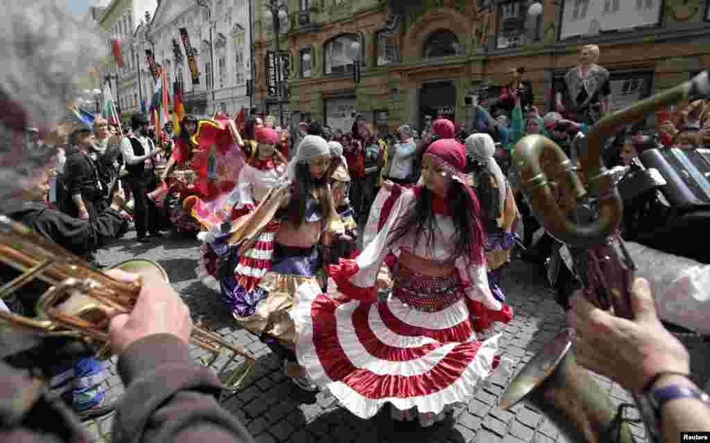 Participants of the Khamoro World Roma Festival dance through the historical center of Prague, Czech Republic. The festival aims to showcase Roma culture and improve relations between society and members of the Roma community.