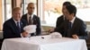 US President Donald Trump speaks with Japan's Prime Minister Shinzo Abe during a luncheon at the Kasumigaseki Country Club Gold Course in Tokyo, Nov. 5, 2017. The president and prime minister signed white hats reading “Donald and Shinzo Make Alliance Even