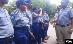 Acting police chief Matanga inspecting some policemen and police woman.
