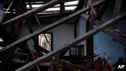 A stained glass window is visible across the sanctuary of the St. James African Methodist Episcopal Church on Jan. 9, 2022, in Mayfield, Ky. A tornado on Dec. 10, 2021, collapsed the auditorium roof and northern-facing wall.
