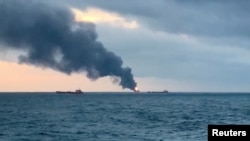 Smoke rises from two ships on fire in the Kerch Strait near Crimea, Jan. 21, 2019 in this still image taken from Reuters TV footage. 