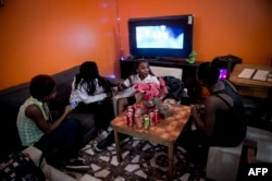 A group of young Haitian migrants gather to talk at a Haitian restaurant in the commune of Quilicura in Santiago, April 24, 2018.