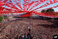 FILE - Supporters of Turkey's President Recep Tayyip Erdogan's ruling Justice and Development Party (AKP) attend an election rally in Gaziantep, eastern Turkey, June 21, 2018.