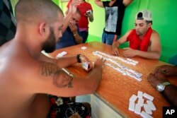 Cuban migrants play dominoes to pass the time at a temporary shelter in La Cruz, Costa Rica, Jan. 12, 2016.