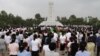 FILE - North Koreans stand together during a meeting in Pyongyang on June 15, 2012, to mark the 12th anniversary of the North-South Joint Declaration. 