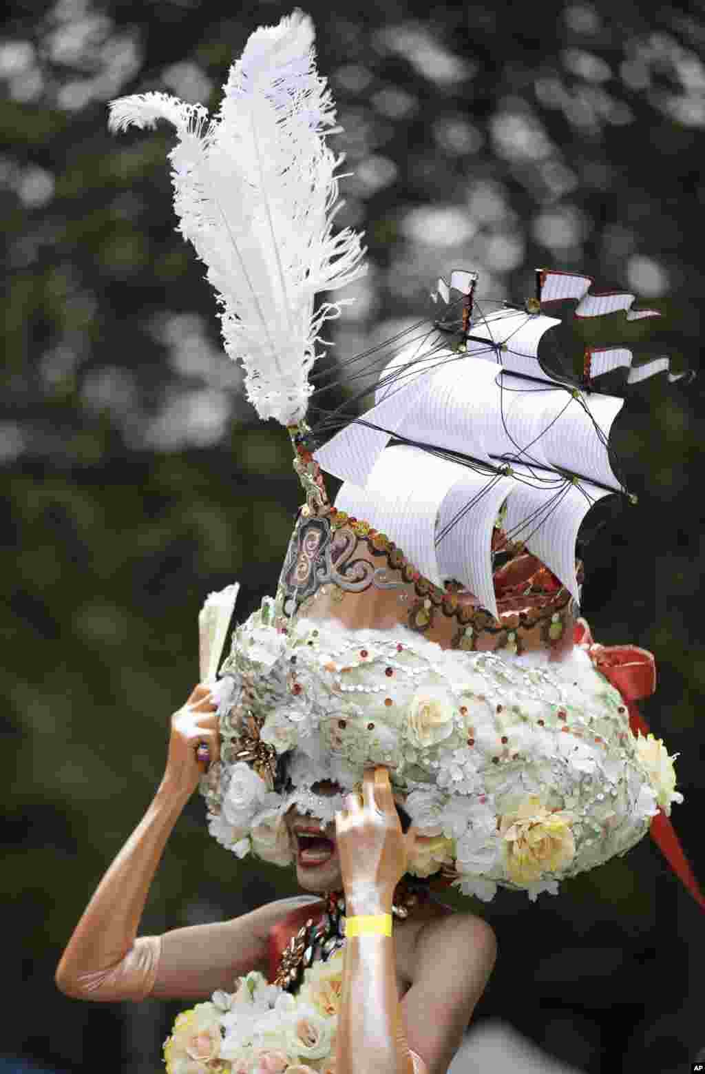 A parade participant wears an elaborate headpiece during Mardi Gras in Sydney, Australia. 10,000 revelers marched alongside 115 floats in the annual parade that celebrates lesbian and gay pride. 