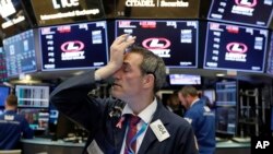 Trader Gregory Rowe works on the floor of the New York Stock Exchange, Tuesday, Oct. 23, 2018. 