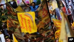 Kurdish supporters of the Labor, Freedom and Democracy Platform wave flags and flash v-sign during an election rally for independent candidates backed by the platform, in Istanbul, Turkey, on June 5, 2011
