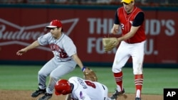 Rep. Raul Ruiz, D-Calif. (L) tags out Rep. Mike Bishop, R-Mich., on the steal attempt with Rep. Tim Ryan, D-Ohio (R), during the Congressional baseball game, June 15, 2017, in Washington. 
