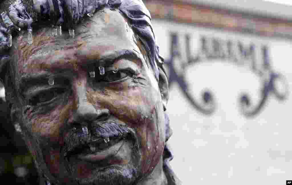 Icicles hang from a statue of Jeff Cook of the band Alabama in Fort Payne, Alabama, Feb. 12, 2014.