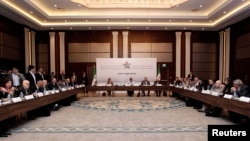 Syrian Opposition Coalition members and Syrian National Coalition members attend a meeting in Istanbul, March 18, 2013. 