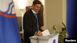 FILE - Incumbent President Borut Pahor casts his ballot at a polling station during presidential elections in Sempeter pri Novi Gorici, Slovenia, Oct. 22, 2017.