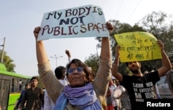 FILE - Students and teachers of Jawaharlal Nehru University participate in a protest demanding suspension of a professor accused of sexual harassment, in New Delhi, March 23, 2018.