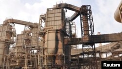 FILE - A view of a damaged production unit after a bomb attack by militants at Baiji oil refinery, 180 kilometers north of Baghdad, Iraq, Feb. 26, 2011. 