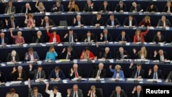 FILE - Members of the European Parliament take part in a voting session in Strasbourg, France, April 12, 2016. 