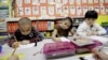 FILE - Kindergarten students work in a bilingual English-Spanish class at school in Texas. 