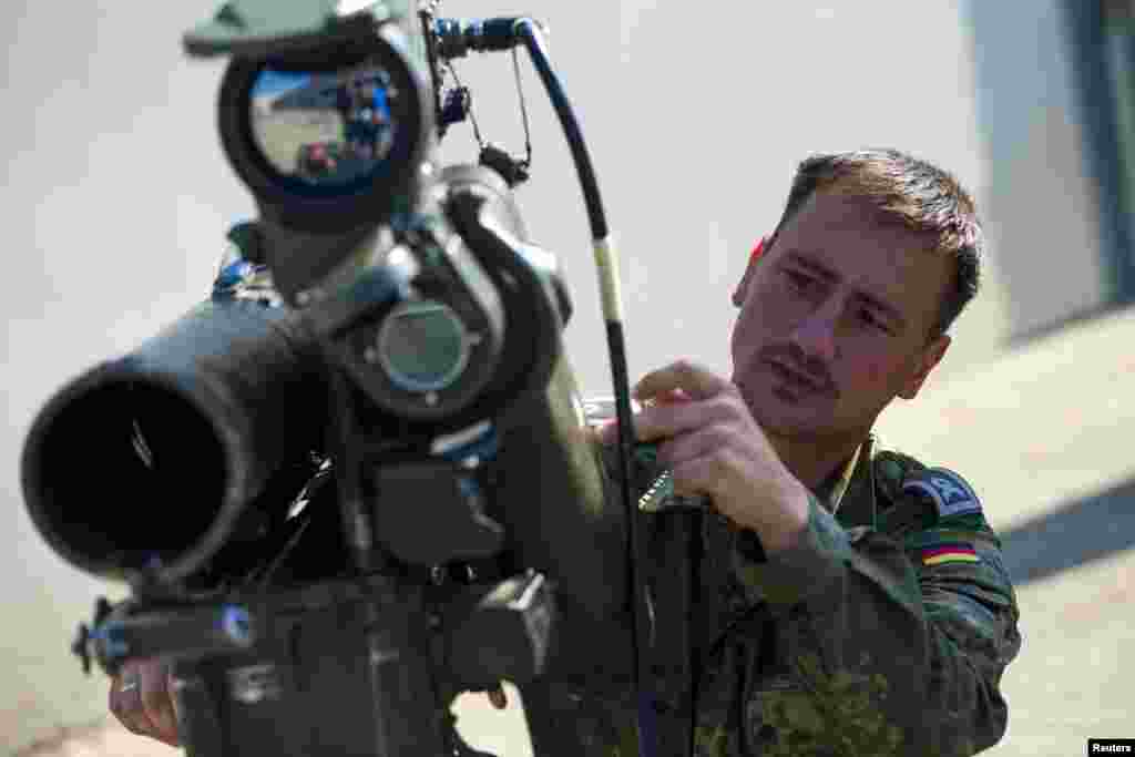 A soldier demonstrates using a Milan anti-tank rocket launcher that is part of a German military aid shipment for Kurdish forces in Northern Iraq at a storage facility of the Bundeswehr armed forces in Waren, north of Berlin, Sept.&nbsp;18, 2014. 