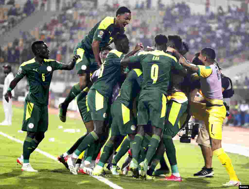 Senegal&#39;s Famara Diedhiou celebrates scoring their first goal with teammates against Equatorial Guinea in Cameroon, Jan. 30, 2022.