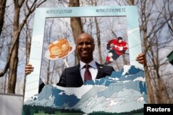 Canada's Immigration Minister Ahmed Hussen poses for photos following a citizenship ceremony at the Vanier Sugar Shack in Ottawa, Ontario, Canada, April 11, 2018.